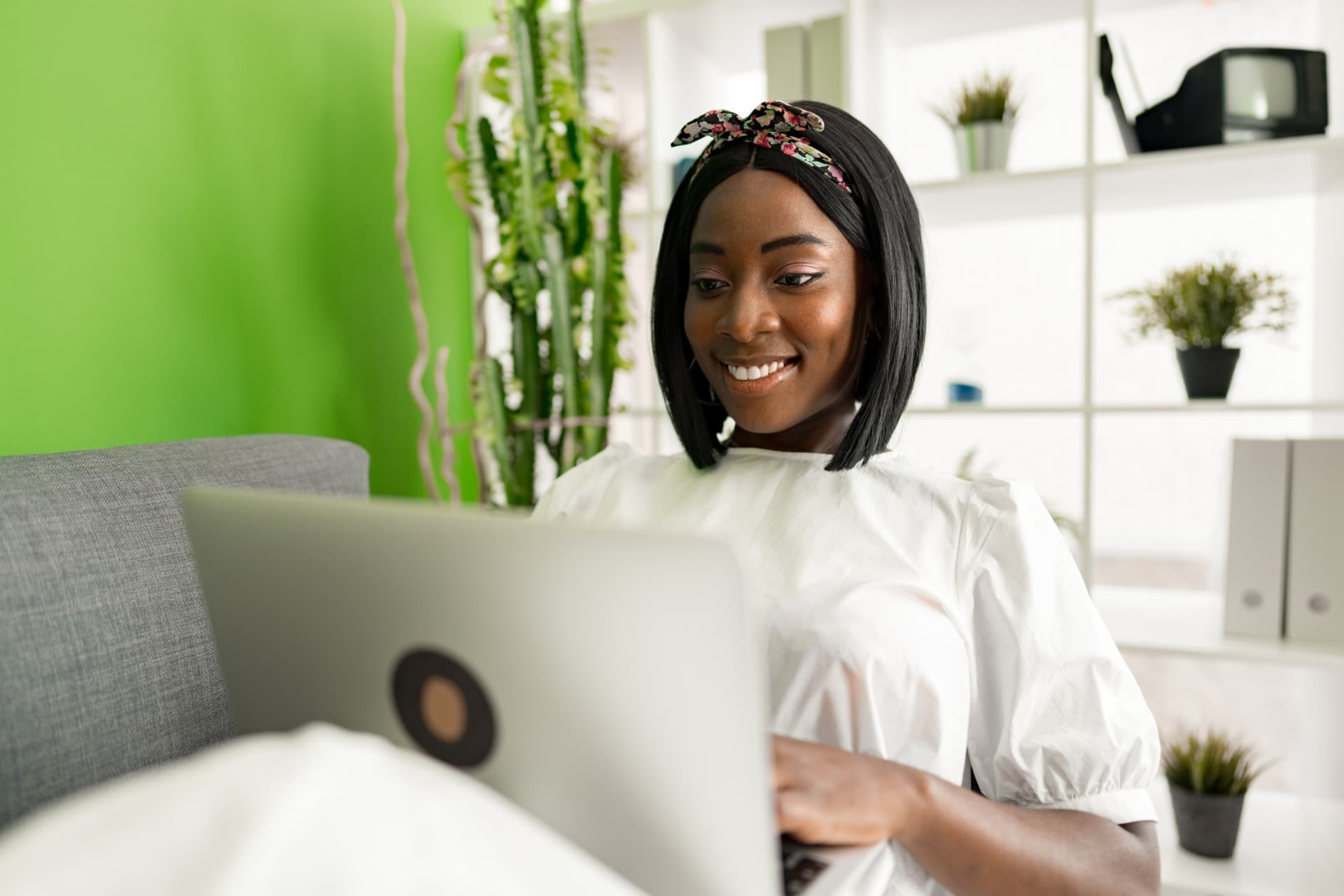 Woman smiling while working on her laptop at home