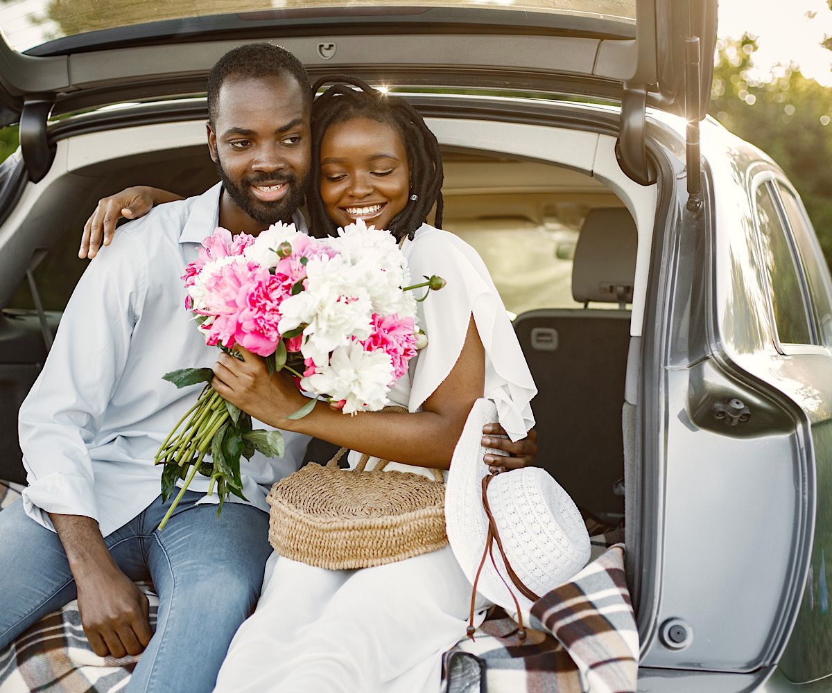 Young happy couple in a park sitting in car trunk by prostooleh