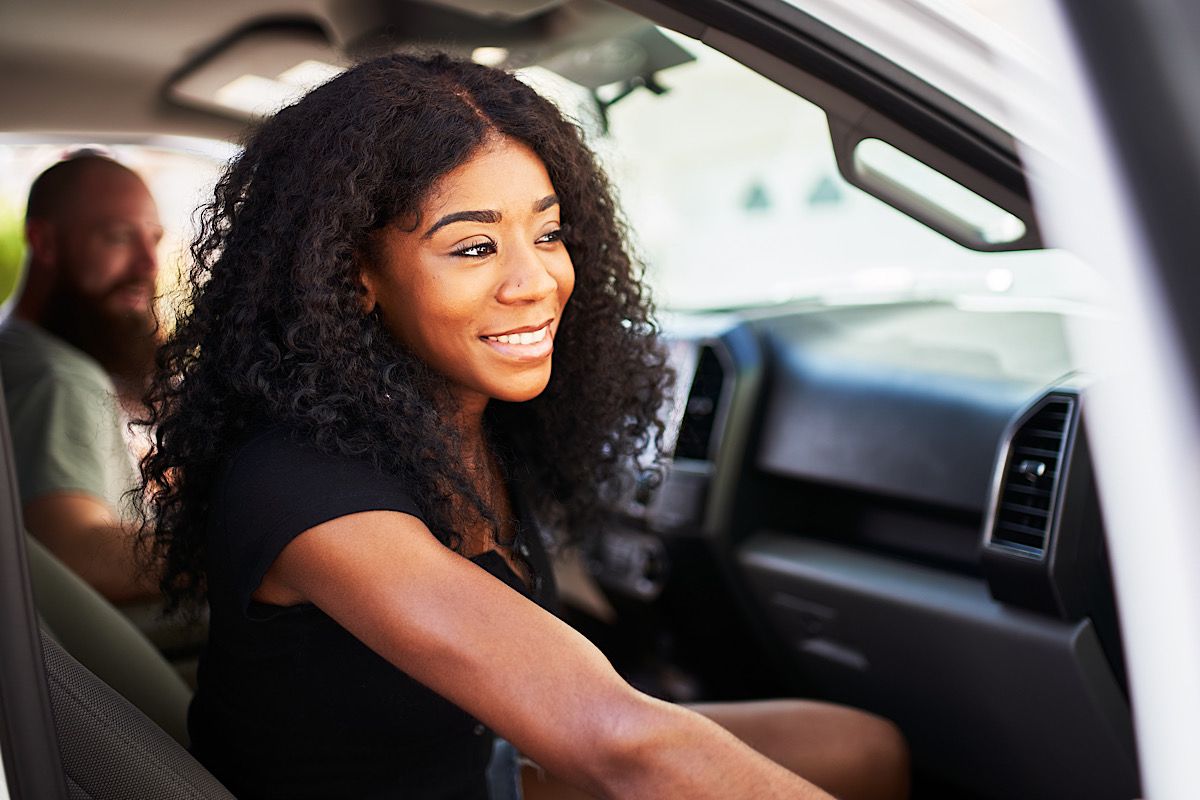 Woman Smiling in Car with a Second Person by joshua_resnick